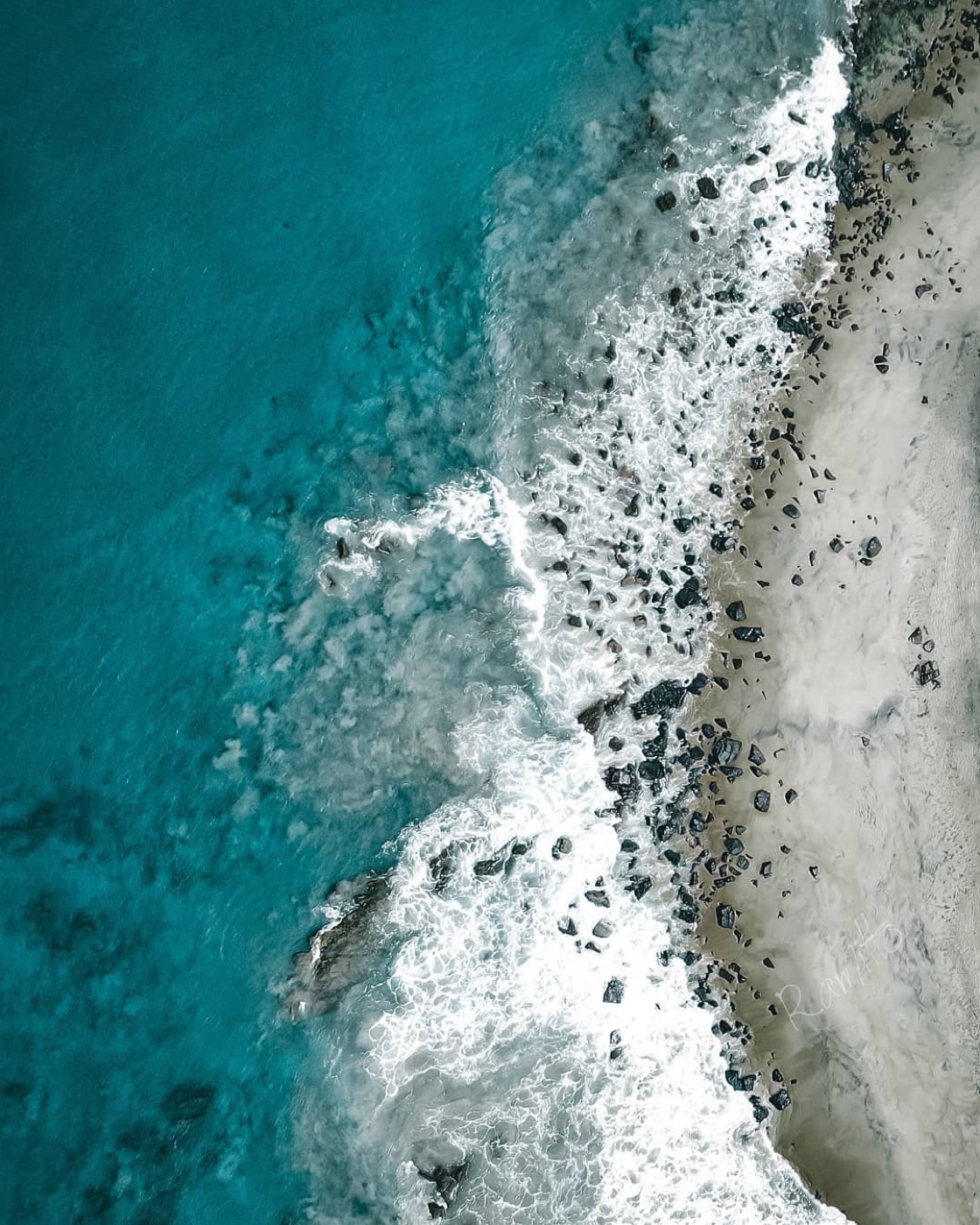 An aerial view of the ocean meeting Robertsport Beach in Liberia